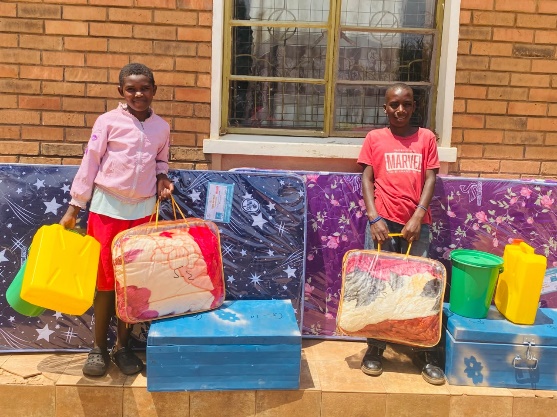 Two boarding students with their mattresses, blankets and supplies